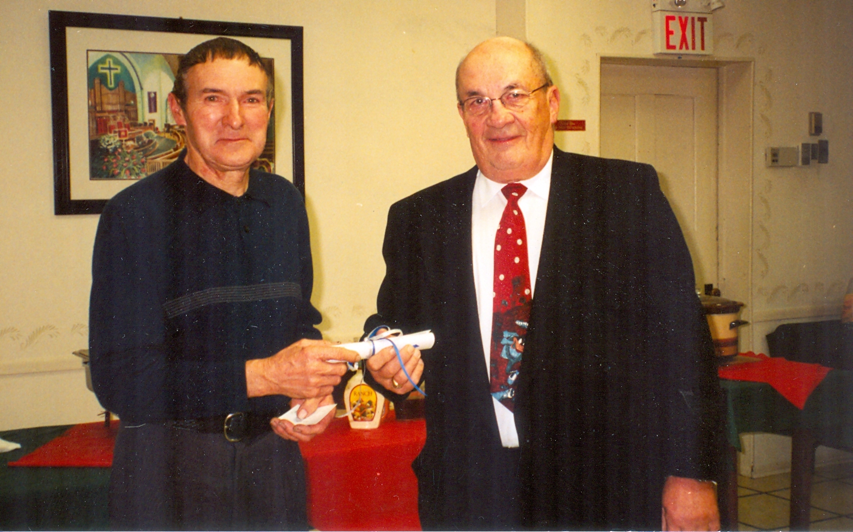 two men shaking hands holding certificate